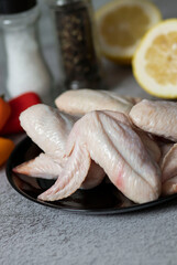 
raw chicken wings on gray background