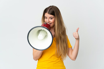 Young blonde woman isolated on white background shouting through a megaphone to announce something...