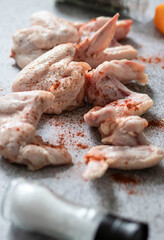 
raw chicken wings on gray background