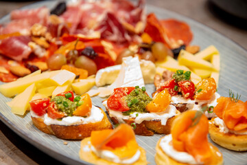 close up of bruschetta on variety of  italian cold cut board