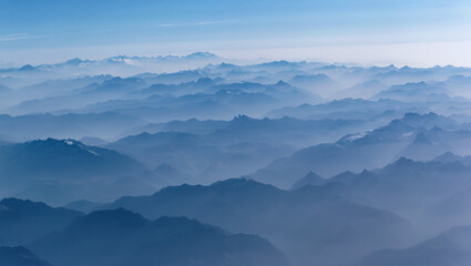 Aeria view of the blue foggy  Alps mountains