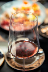 close up of red wine glass on table