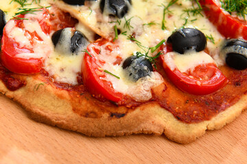 homemade pizza, vegetarian food, baked vegetables and cheese, tomatoes and olives, delicious food on a wooden background