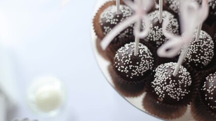 Chocolate muffins-cakes decorated with coconut on the banquet table. Sweet dessert - Powered by Adobe