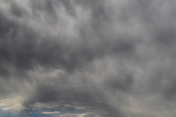 Heavy dark clouds with shining blue sky.