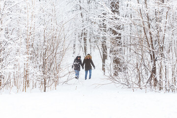 Happy loving couple having fun outdoors in snow park. Winter vacation