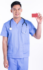 Portrait of young doctor smiling, holding credit card and standing on white background