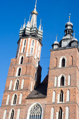 Fototapeta na wymiar Krakow, Poland - February 17, 2019: Old city center view with Adam Mickiewicz monument and St. Mary's Basilica in Krakow
