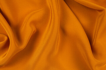 Fototapeta premium Golden silk or satin luxury fabric texture can use as abstract background.