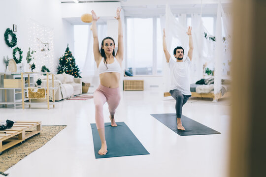 Slim woman and sporty man doing lunges