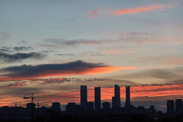 The sunset behind the Cuatro Torres de Madrid seen from the Valdebebas forest park. Spain