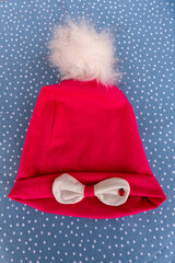 red hat with fur and white pompom