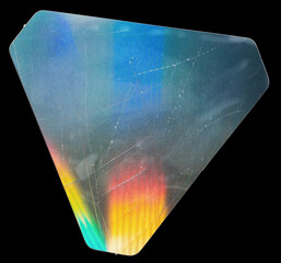 triangular shiny foil sticker with cool neon rainbow surface on real paper sheet isolated on black...