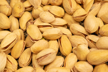 Salted pistachios lie on the burlap. Close up.