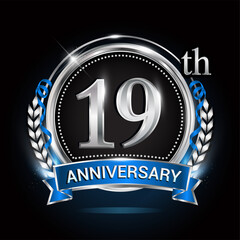 19th silver anniversary logo with blue ribbon and ring.