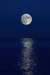 Naklejka na ściany i meble Full moon reflection over the evening sea in Spanish Costa Brava