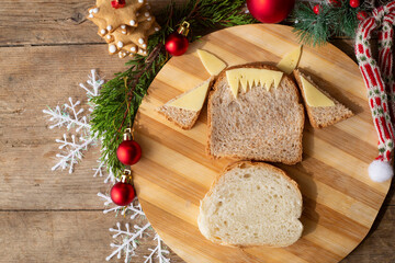 edible bull, symbol of 2021. A funny sandwich in the shape of a bull made of ham, cheese, bread, with a cucumber. children's breakfast. New Year's, Christmas food. Instruction, recipe