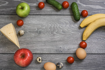 Fresh vegetables, fruits and ingredients for cooking around empty space on wooden background, top view, copy space. Ketogenic diet, healthily food.