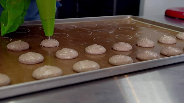 baker making macarons in bakery