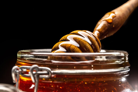 Jar Of Honey With Dipper Closeup - Studio Shot