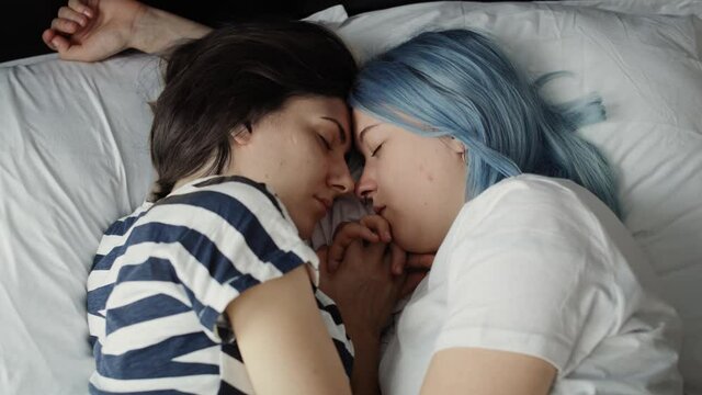 Close up video of lesbian couple sleeping on bed. Shot with RED helium camera in 8K.