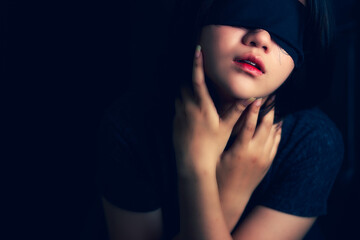 Blindfolded woman Concepts against violence in women And reflect inequality in society Dark tone style