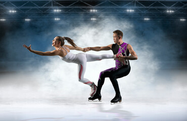 Duo figure skating in action on dark background