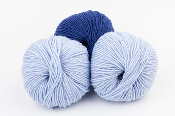 woolen merinos blue threads on white background. natural wool. knitting. background