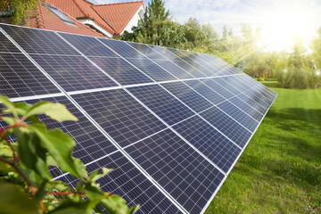 Solar panel, photovoltaics, alternative source of electricity - set in the garden by the house.