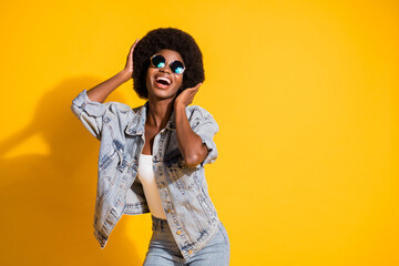 Photo of pretty sweet lady wear casual denim outfit arms fixing hair isolated yellow color...