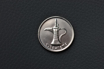 Extreme close up of embossed 'Dallah' or coffee pot graphic from UAE dirham coin. Close up of one dirham coin.