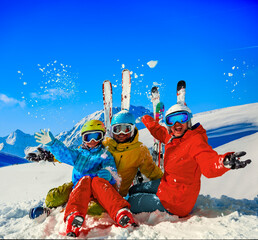 Happy family enjoying winter vacations in mountains . Ski, Sun, Snow and fun.