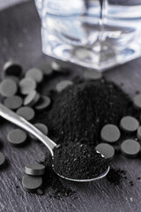 activated carbon on a dark stone background