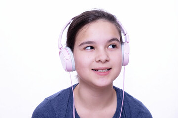 teenage girl in pink headphones, on a white background