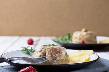 Two plates of cold beef and chicken with lemon slices and mustard. Copy space
