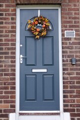 Hardwood grey front door with decorative autumn wreath