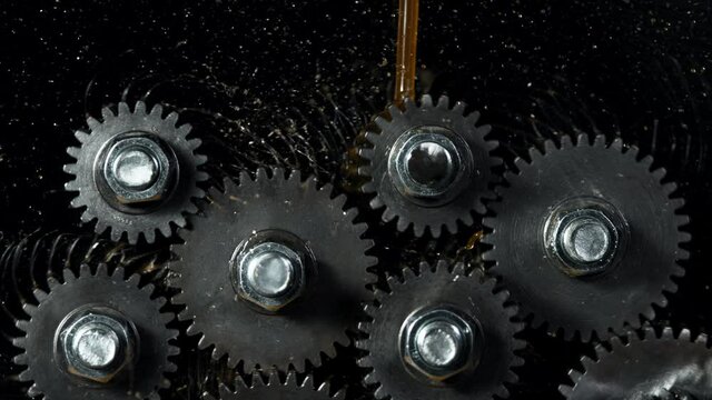 Super slow motion of rotating engine steel wheels with oil splashes. Filmed on high speed cinema camera, 1000 fps.