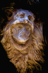 Fragment of very ancient stone statue of Hercules wearing Nemean lion skin. Selective focus on eyes.