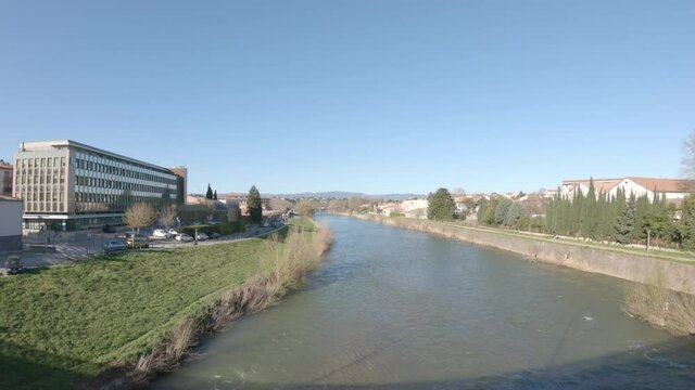Carcassonne / Languedoc-Roussillon / France - March 15, 2020: SLOW MOTION The Aude River and the CPAM de l'Aude (the local Health Insurance Funds (Caisses Primaires d'Assurance Maladie/ CPAM) building