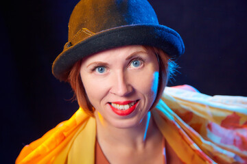 Portrait of middle-aged woman with hat. Ugly model in yellow autumn stile posing in studio.