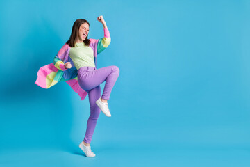 Full length photo of lucky funny lady wear casual colorful outfit dancing fists up open mouth isolated blue color background