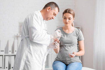 Pregnant diabetic woman visiting doctor in clinic