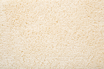 Fototapeta na wymiar New light beige shaggy carpet background. Closeup. Empty place for text or logo. Top down view.
