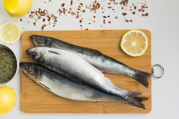 Cooking fish with lemon and spices. Ingredients on a white background.