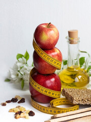 red apples with a centimeter on a white background, diet, fitness, proper nutrition, excess weight