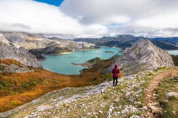 Fototapeta premium Chica mirando embalse de Riaño desde lo alto de la montaña en España.