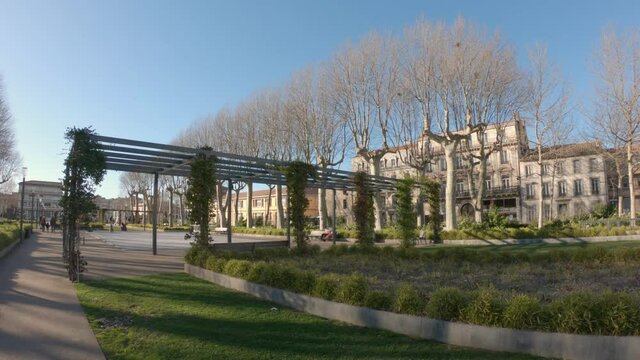 Carcassonne / France - March 11, 2020: DOLLY SHOT SLOW MOTION - The bronze sculptures of the Catalan artist Marta Solsona adorn the flowered alleys of Square Gambetta.