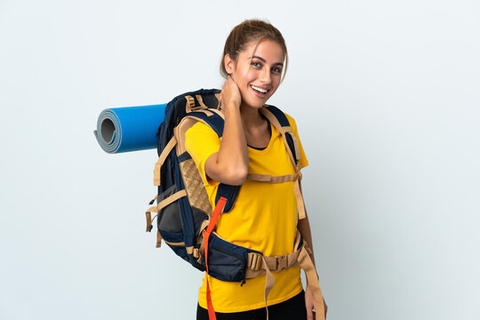 Young Mountaineer Woman With A Big Backpack Isolated On White Background Laughing