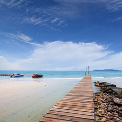 Wooden bridge, corridor to the sea on Beautiful crystal clear sea and tropical beach at tropical paradise island, Thailand