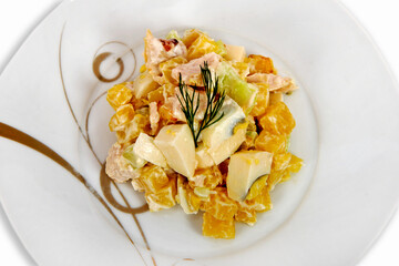 Salad with boiled vegetables and egg seasoned with mayonnaise on the plate.Top view.